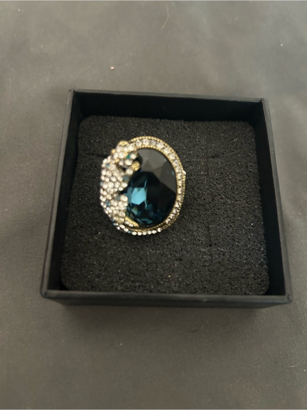 HEIDI DAUS Elegant Gold-Tone Ring with Deep Teal Crystal and Clear Rhinestones